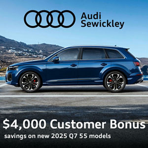 Side view of an Audi Q7 driving.